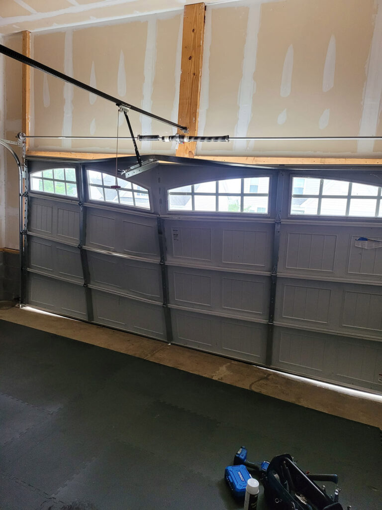 Technician performing garage door alignment service in San Rafael CA