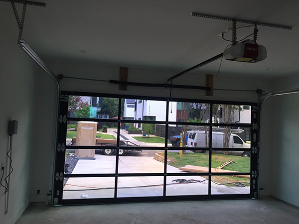 Technician repairing garage door hinges in San Rafael California